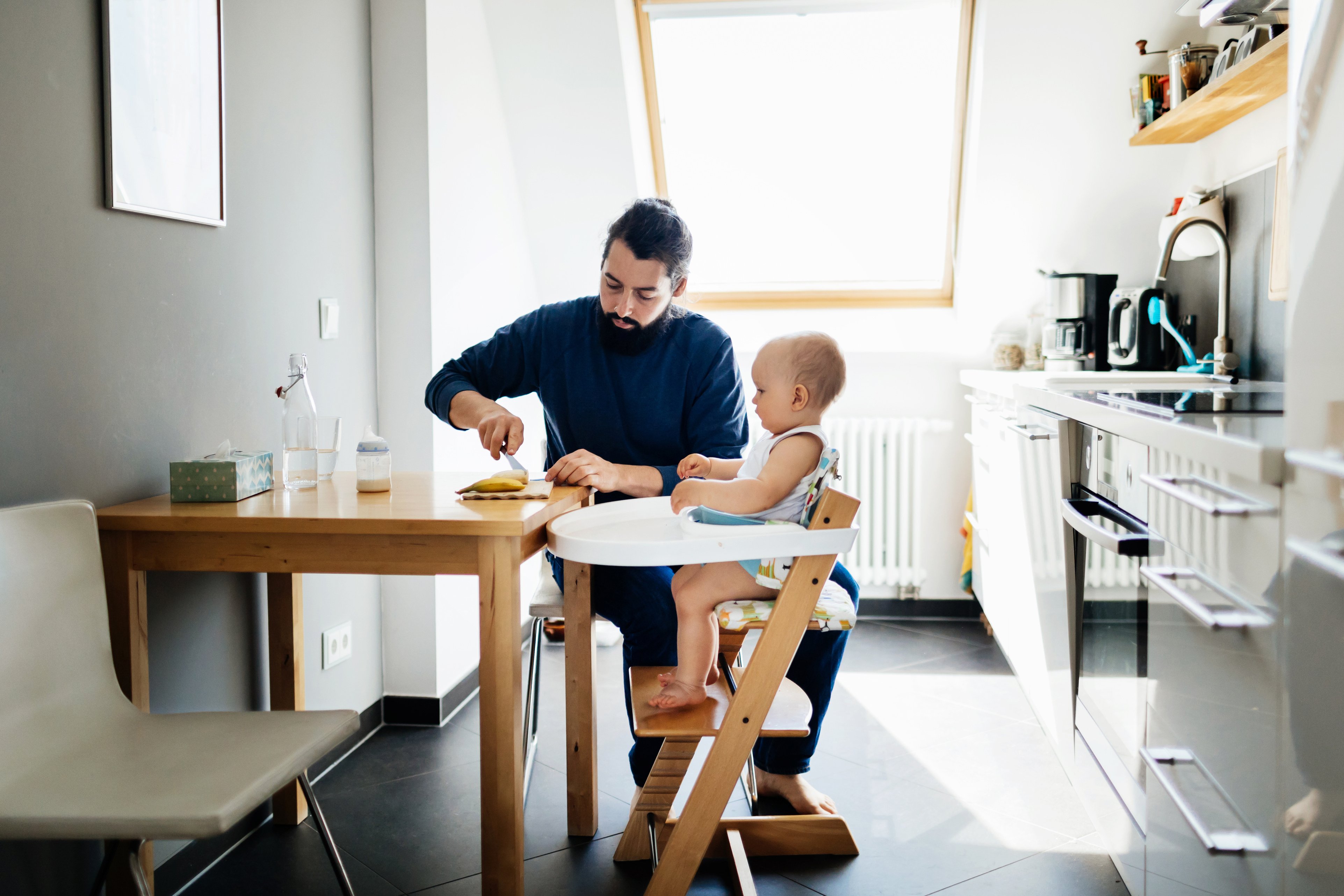 Single Father Feeding Baby In high Chair